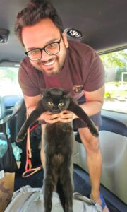 Nyx, a black cat, being picked up by a pet transport driver for her flight to Singapore.
