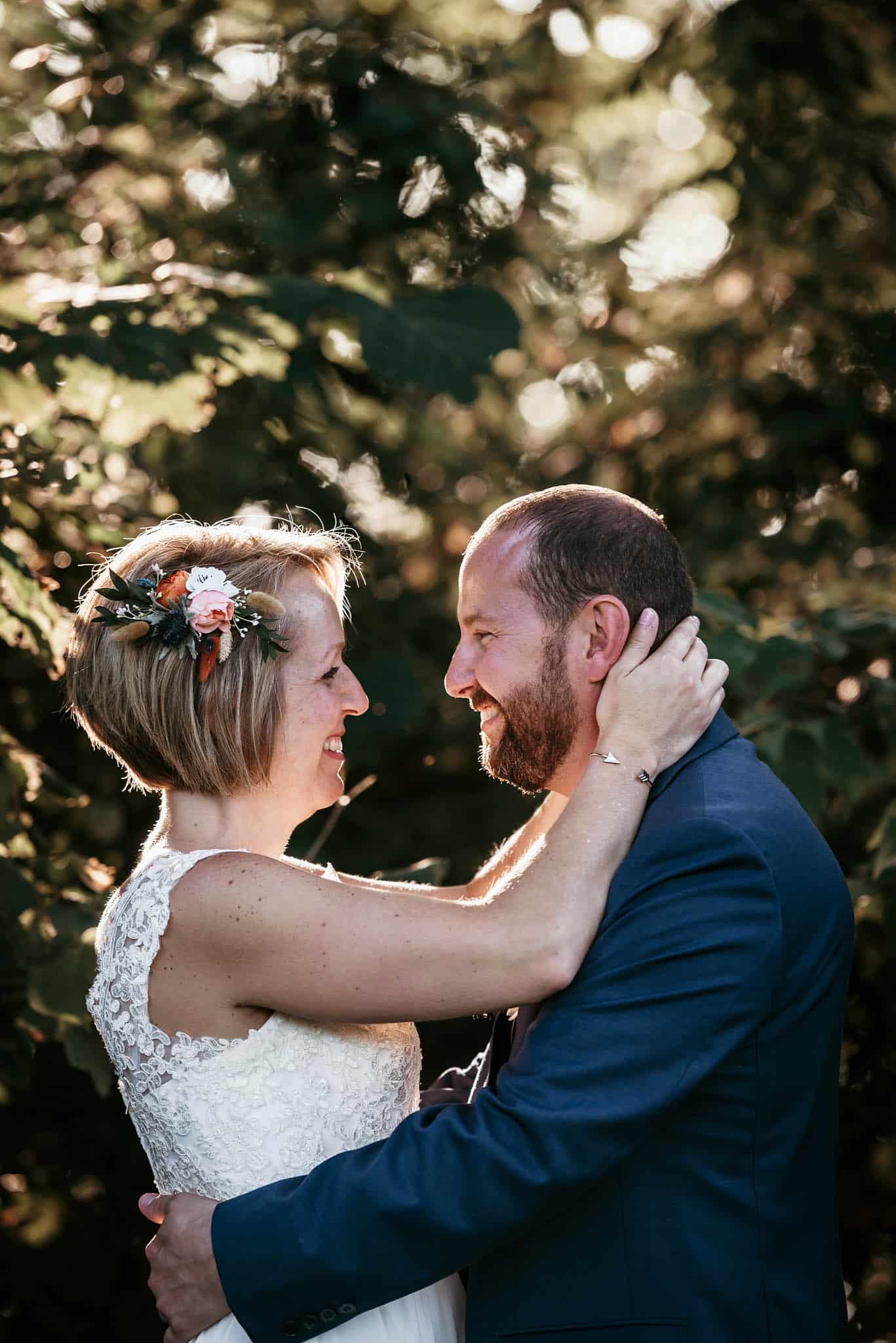 Bride and groom looking at each other in front of trees after outdoor wedding ceremony at Pokagon State Park