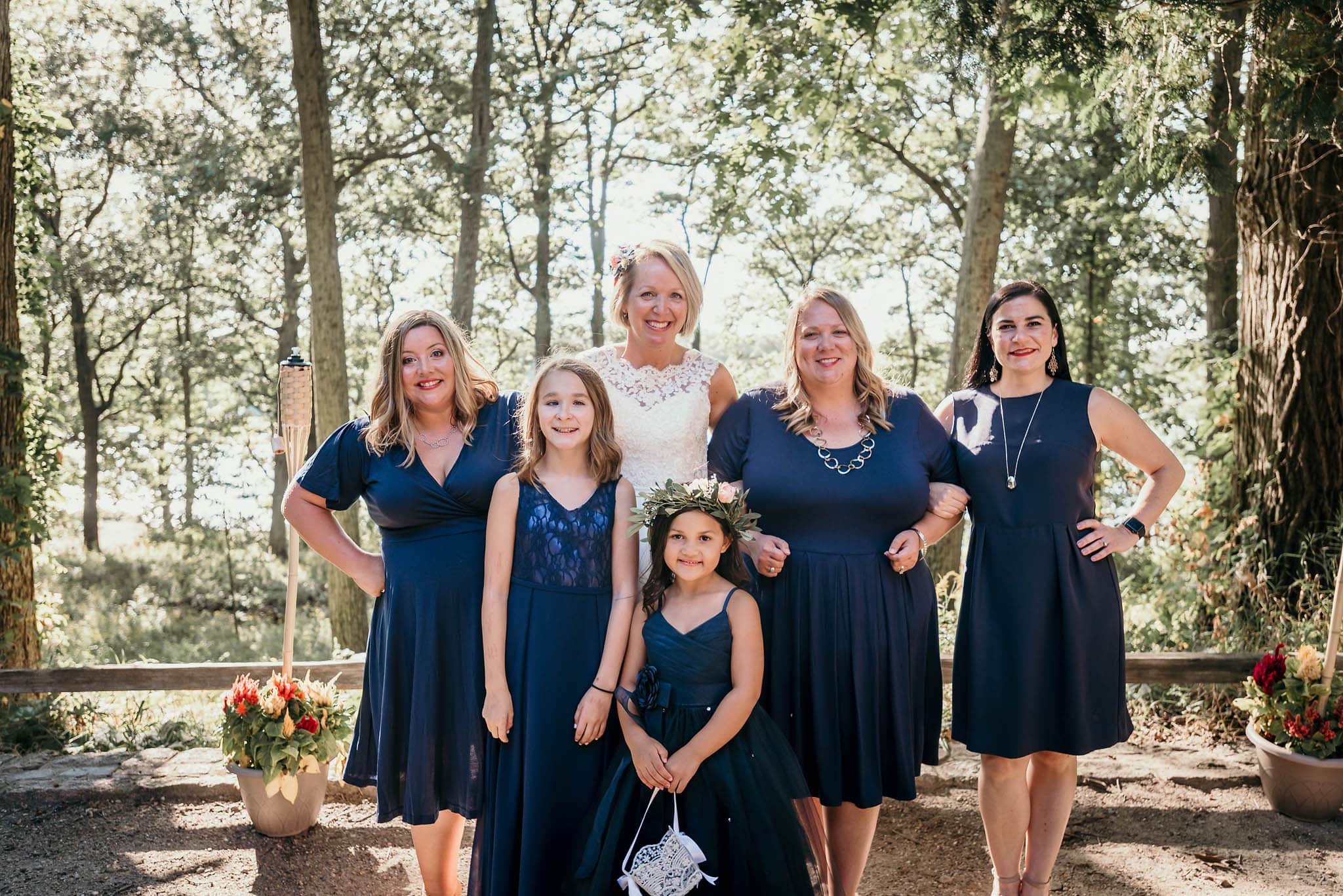 Bride posing with bridesmaids outdoors at CCC Shelter at Pokagon State Park