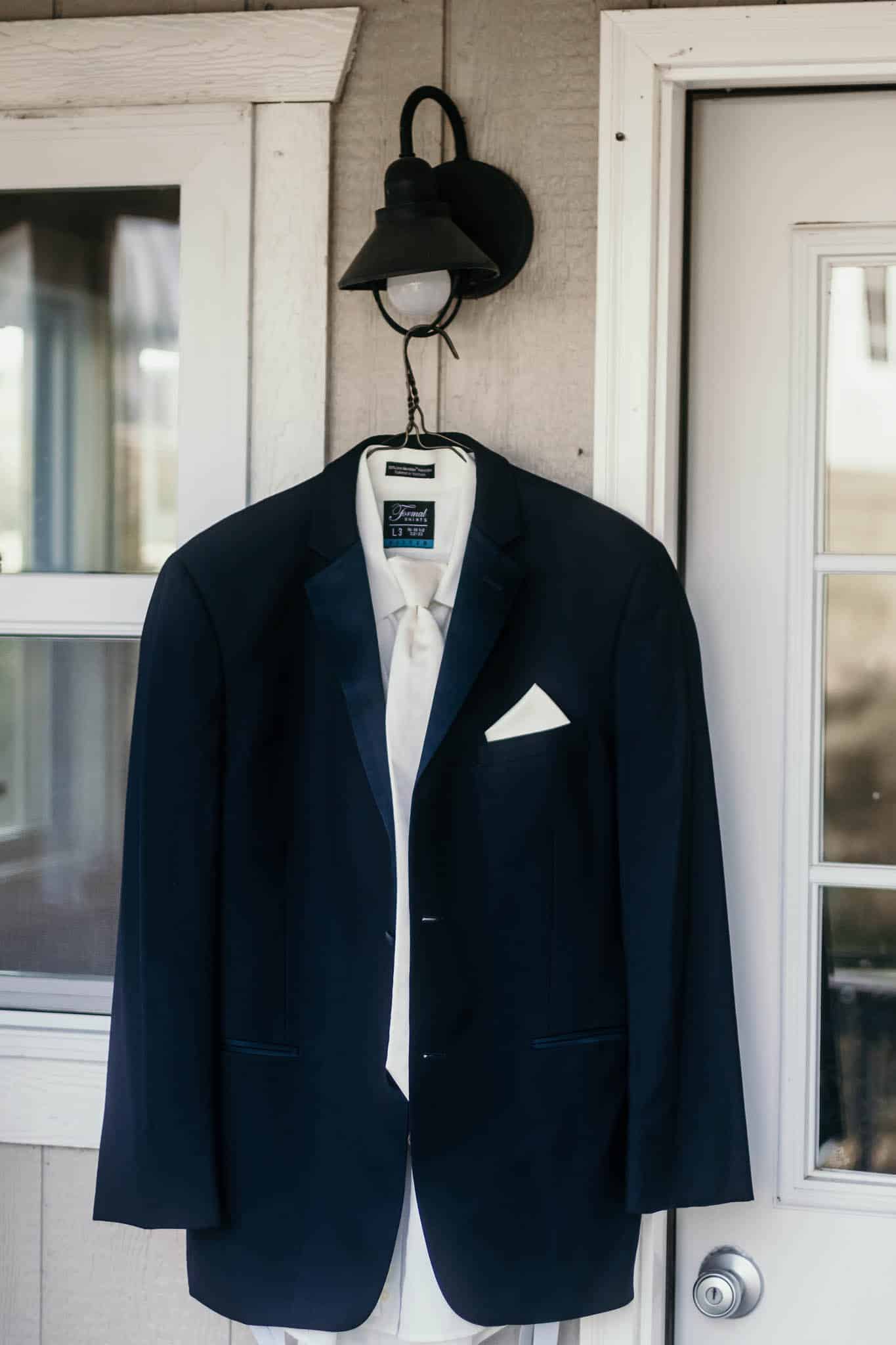 Groom's suit hanging outside cabin during prep