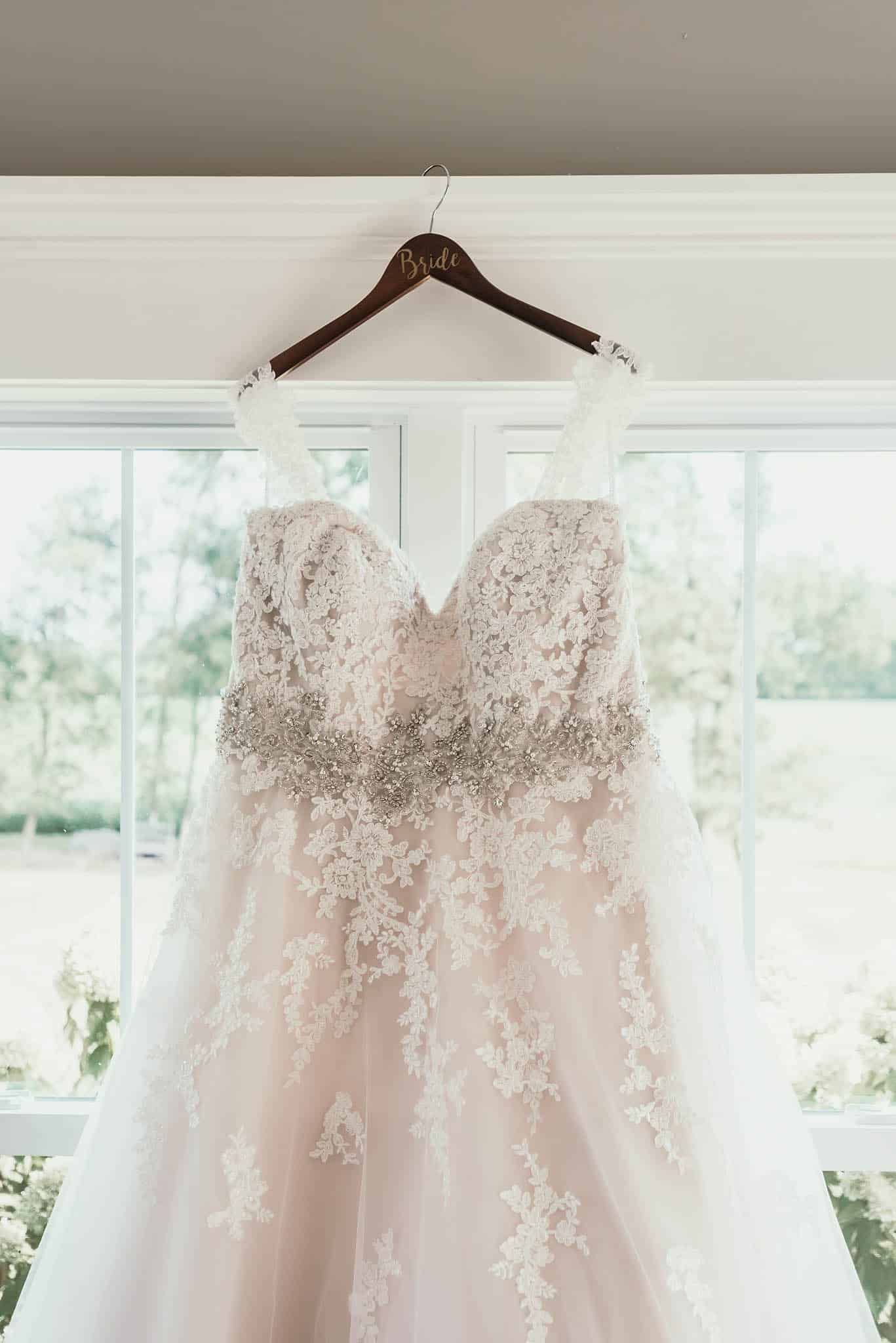 Lace wedding dress details on custom hanger
