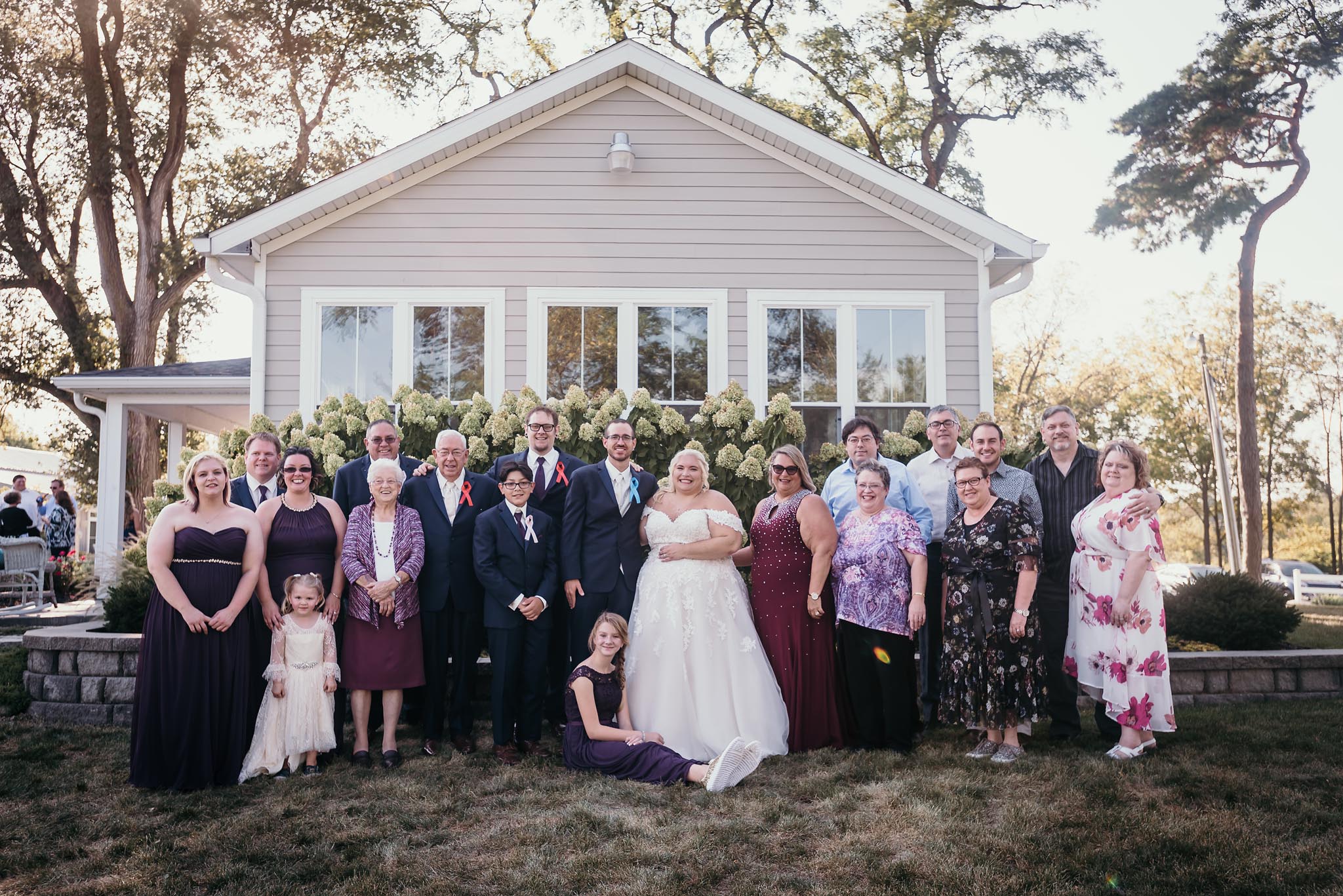 Large group family photo during outside intimate fall wedding at the Lodge at River Valley in Yorktown, Indiana