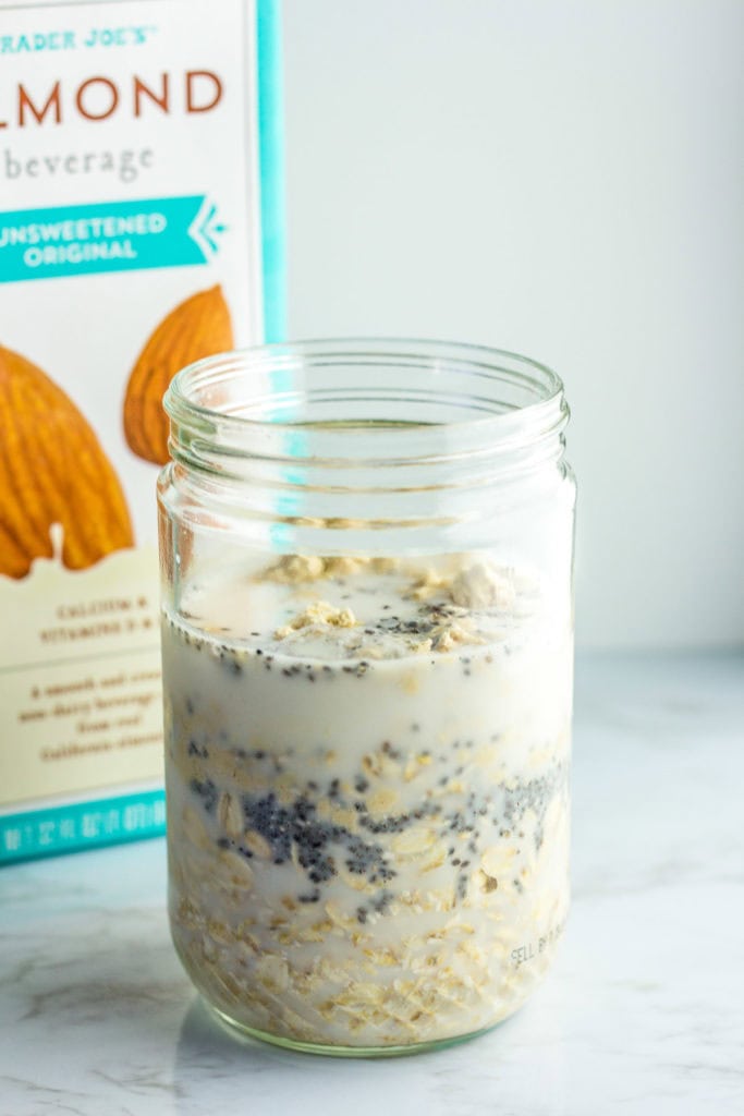 rolled oats, chia seeds, protein powder in a mason jar with unsweetened almond milk on top