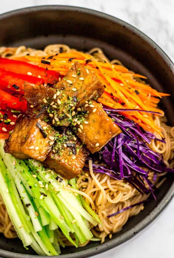 Close up shot of a bowl of Korean noodle salad with soy sauce