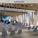 Modern conference space with large windows and seating for attendees.
