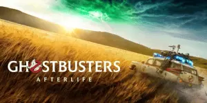 Ghostbusters: Afterlife scene with Ecto-1 vehicle in a field at sunset.