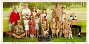 Group of people dressed in various costumes from movies, posing outdoors with a green park backgroun.