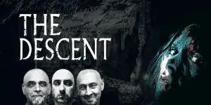 The Descent movie poster featuring three men and a woman in a dark cave setting.