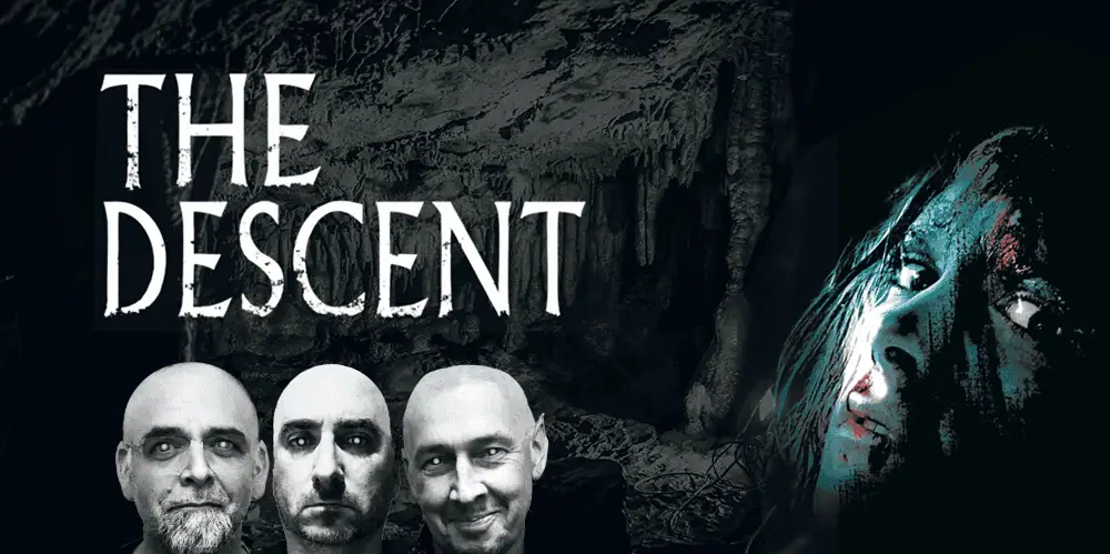 The Descent movie poster featuring three men and a woman in a dark cave setting.