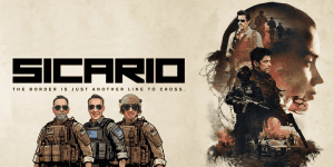 Promotional poster for Sicario featuring border patrol agents and intense imagery.