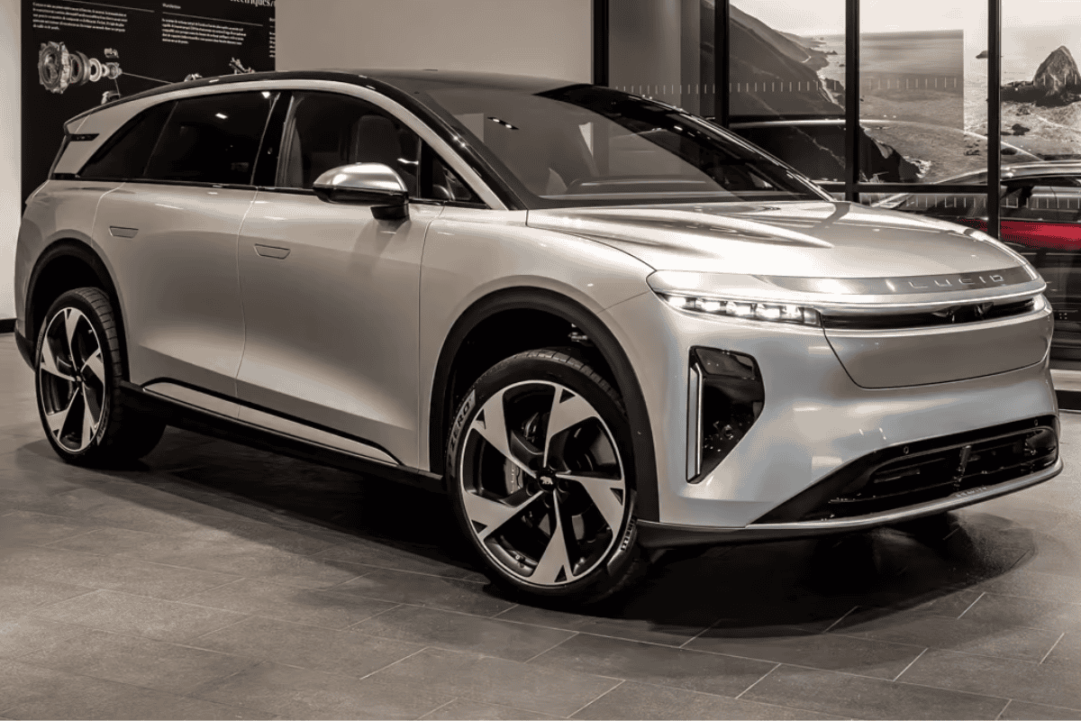Luxury electric SUV displayed in a showroom, showcasing advanced EV technology and sleek design elements.