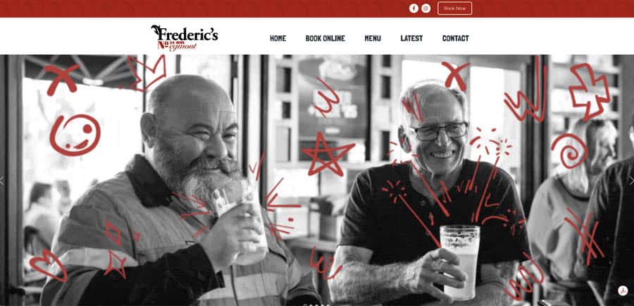 Two men enjoying craft beers at Frederick's Pub, smiling and socialising.