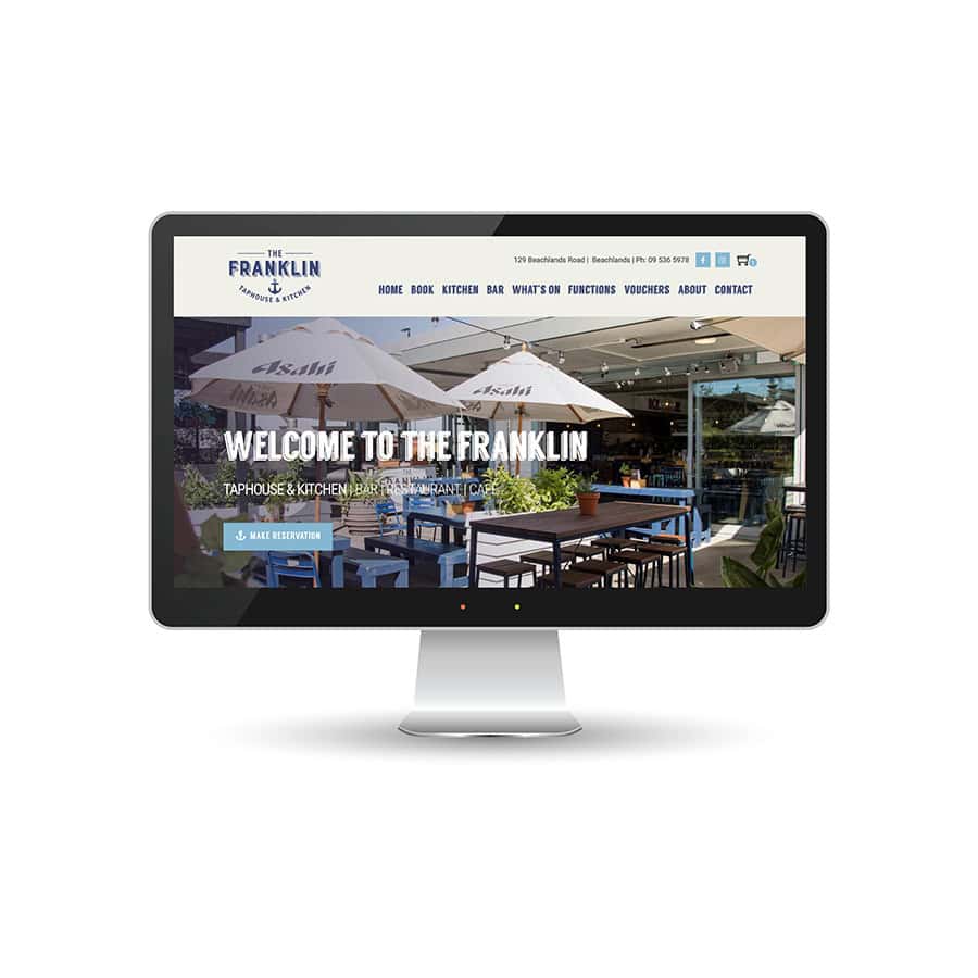 The Frankilin Beachfront restaurant website homepage displayed on a computer monitor with outdoor dining area.