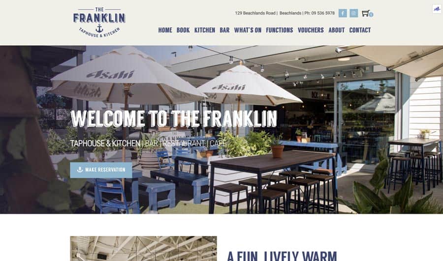 Outdoor dining at The Franklin Tapas & Kitchen with umbrellas and seating, inviting and vibrant atmosphere.