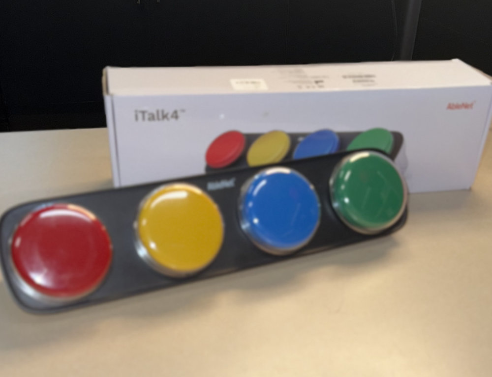 iTalk 4 is a communication device with four large colored buttons—red, yellow, blue, and green