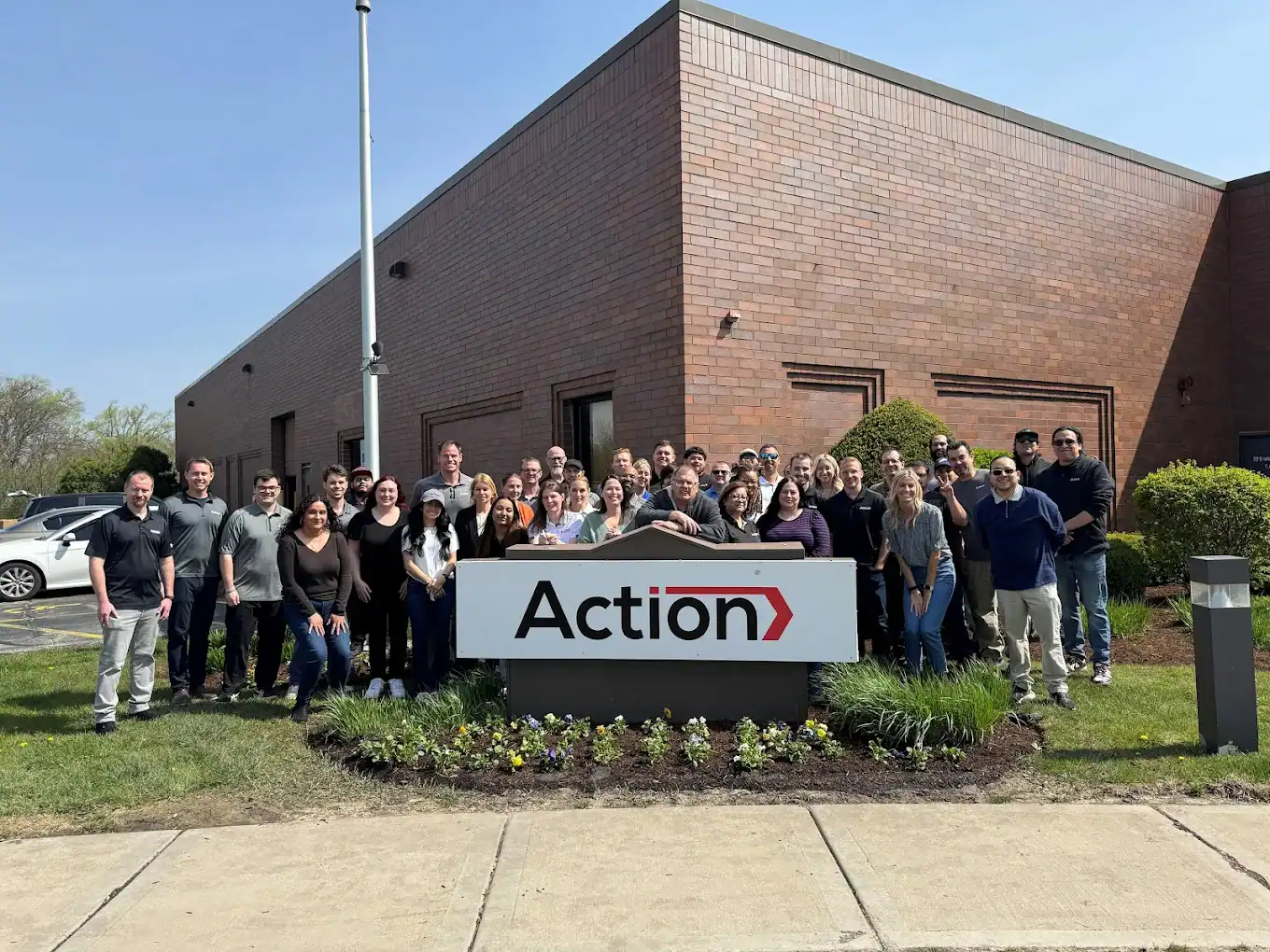 Action Packaging team standing outside company building