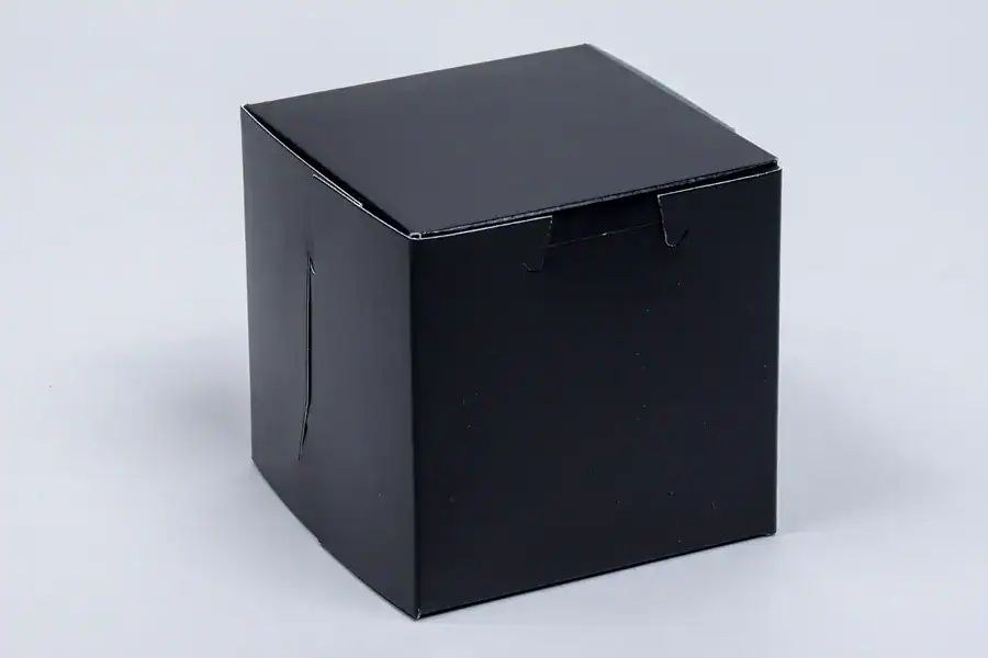 Black 4x4x4 bakery box for packaging desserts and baked goods.