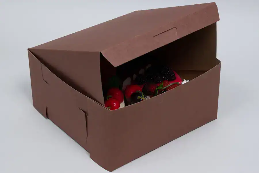 Brown cupcake box with lock corner, open to reveal assorted cupcakes inside.