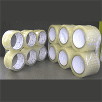 Industrial rolls of clear packaging tape for shipping and wrapping.