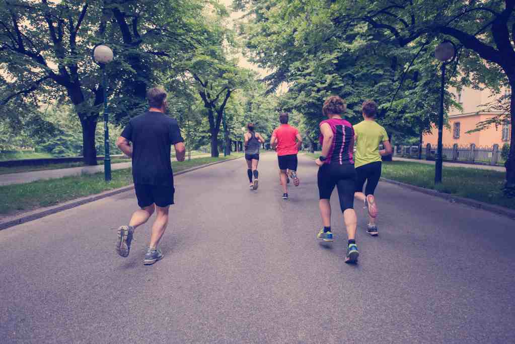 A group of people running through the park