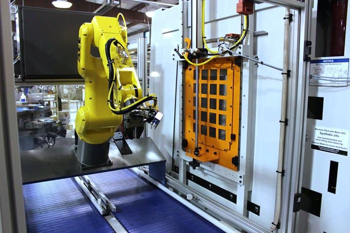 Robotic arm performing precise assembly in electronics manufacturing.