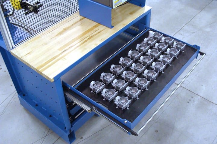 Industrial storage drawer with multiple small components organized inside.