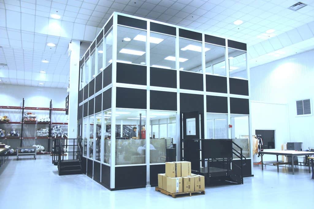 Office pod with glass walls and black framing for flexible workspaces.