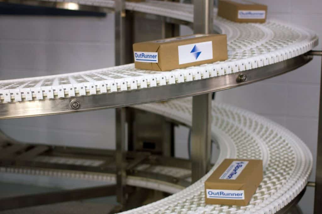 Automated conveyor system with OutRunner boxes in a warehouse.