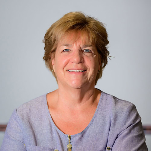 Senior woman leader smiling confidently.