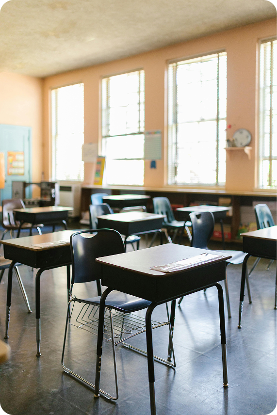 Classroom setup with desks and chairs for learning.