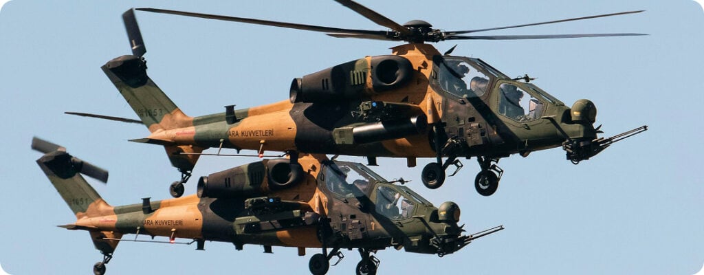 Helicopter flying in clear sky with military camouflage.