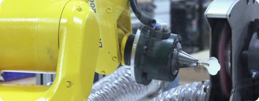 Robotic arm performing material removal deburring at Adaptec Solutions.