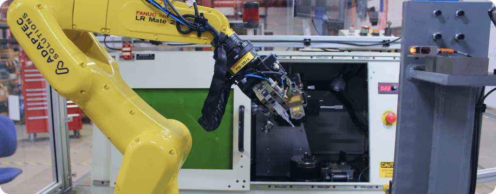robot tending a CNC machine in manufacturing setting