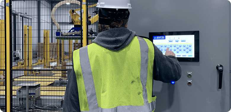 Operator selecting parts on HMI screen for an automation system in a factory
