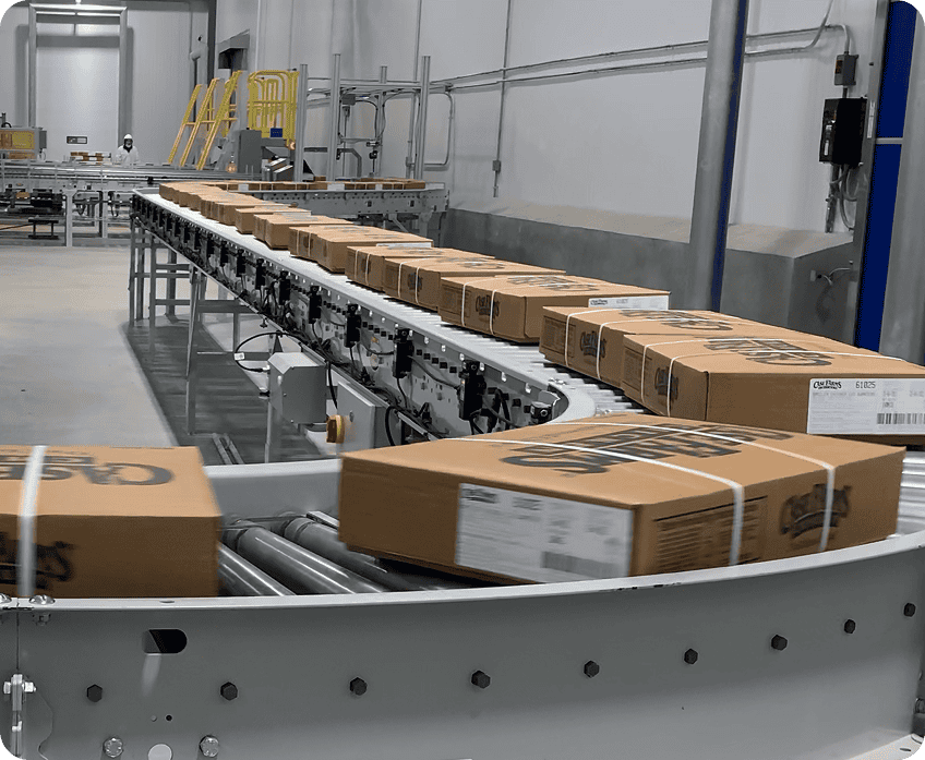 Conveyor line with boxes in a food manufacturing facility