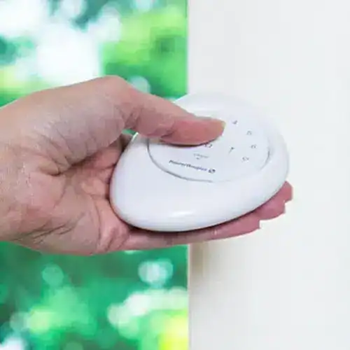 White wireless remote control for window blinds and shades at Advance Blinds & Drapery.