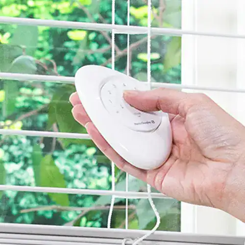 Remote control for motorized window blinds by Advance Blinds & Drapery, offering convenient and modern window treatment solutions.