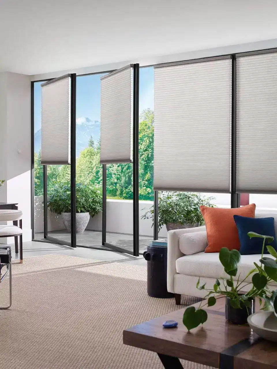 Luxurious modern window blinds installed on large glass sliding doors in a bright, contemporary living room, enhancing natural light control and privacy, with a stylish and functional design.