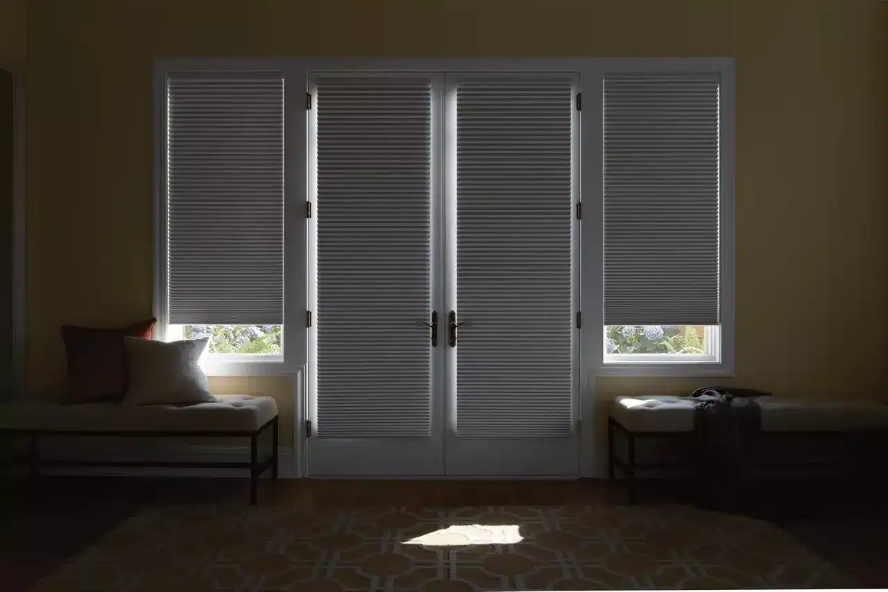 Modern white plantation shutters with double doors and side windows, offering custom window treatment solutions.