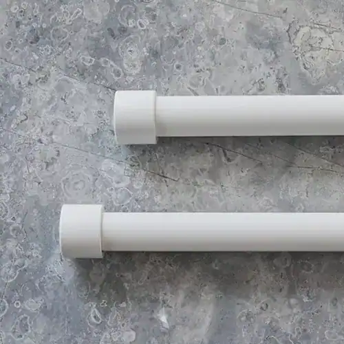 Adjustable white curtain rods for window treatments, perfect for stylish drapery installation and home decor. High-quality hardware for durable and easy curtain hanging.