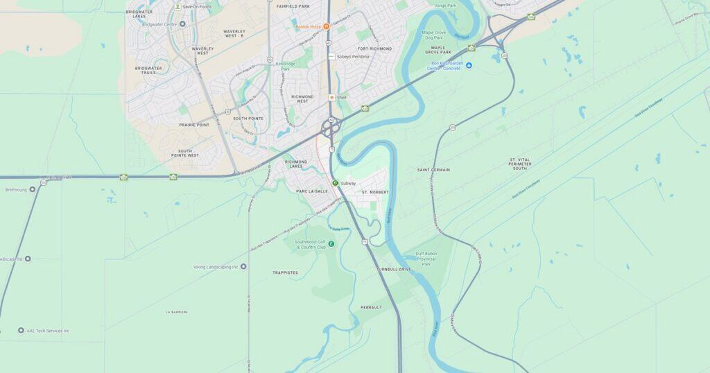 Map of city with river, roads, and transit lines, highlighting urban infrastructure and geographic features.