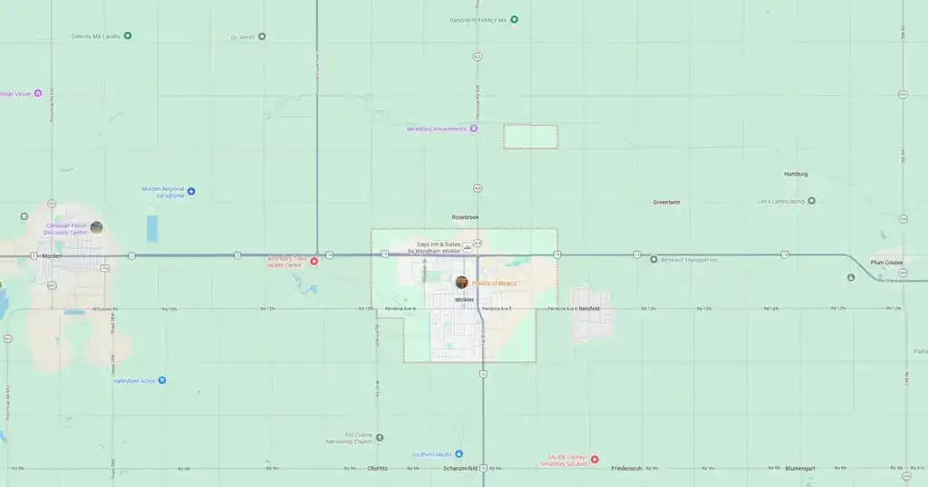 Map of a city with streets, landmarks, and transportation routes in a light green background.