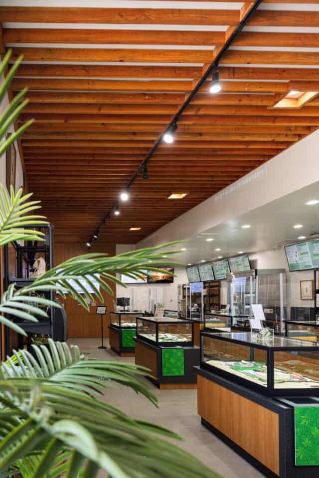 Inside Aloha Green Apothecary Herb House dispensary, showing sales counters and menus in a clean, welcoming space.