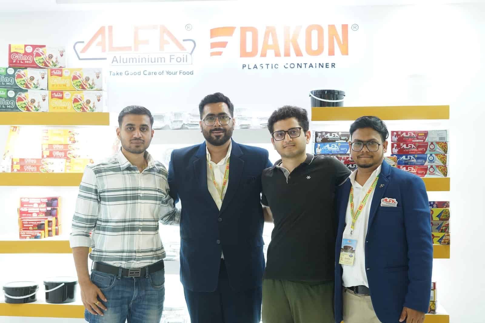 Alfa Foil Containers displayed with DAKON plastic containers at a trade event.