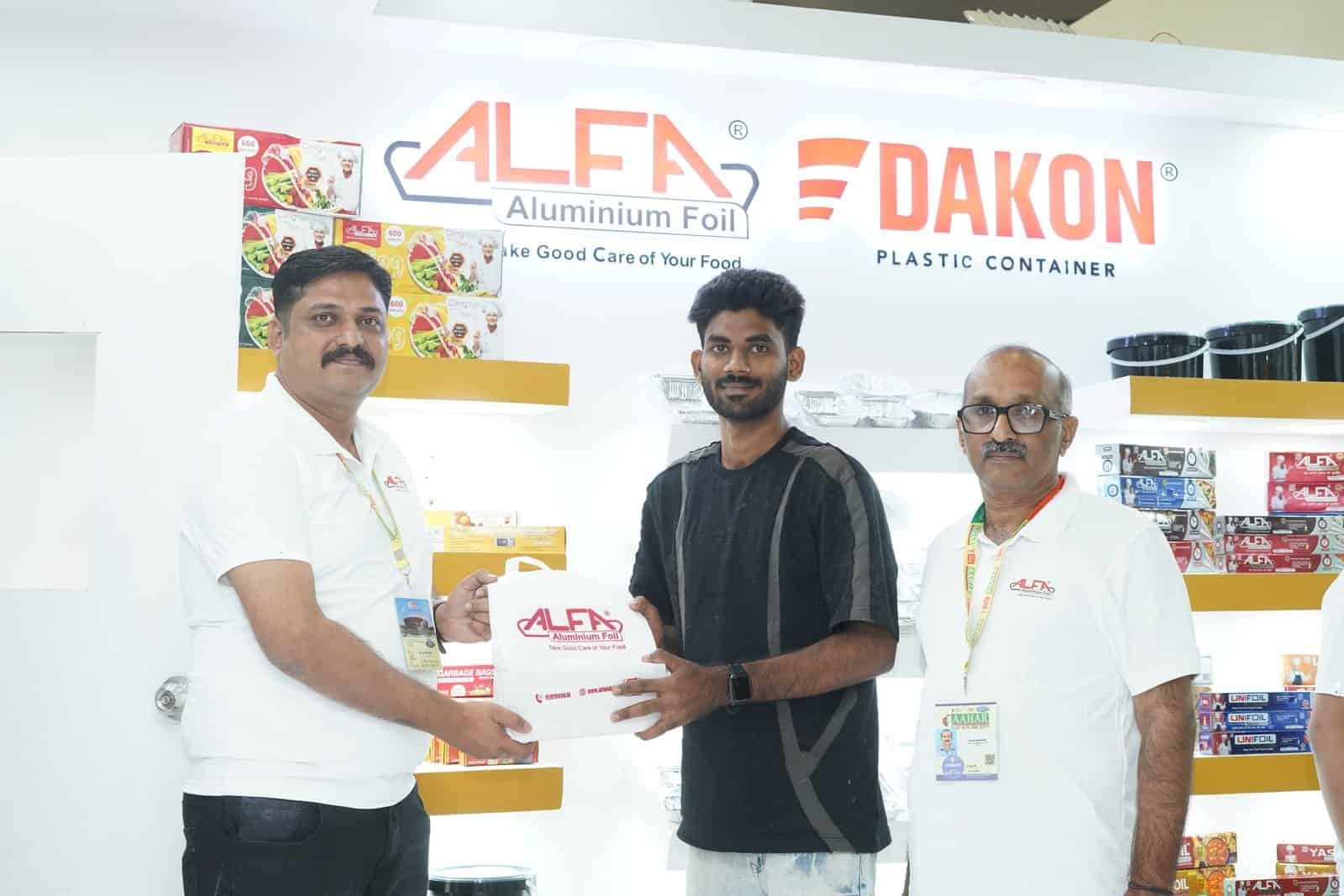 Alfa Foil containers showcased at trade show with representatives.