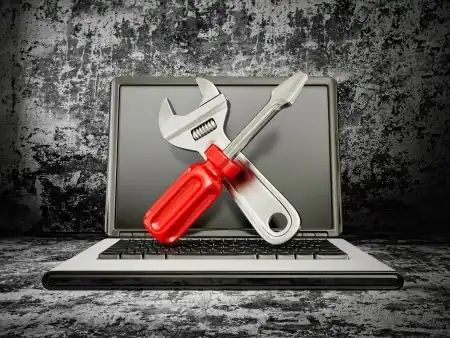 Laptop with wrench and screwdriver for computer repair in Knoxville TN.