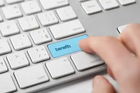 Keyboard key labeled benefits being pressed for managed IT services.