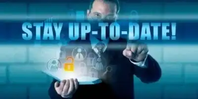 Businessman pointing at digital security and update icons with 'Stay Up-to-Date' text.