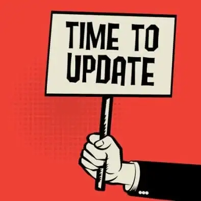 Hand holding a sign that says 'Time to Update' for IT support relevance.