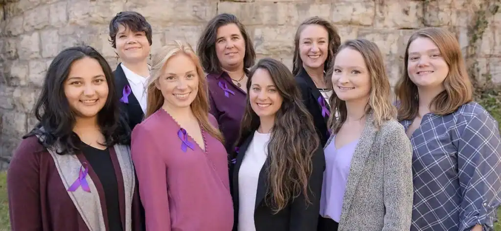 Group of diverse women smiling outdoors during Helping Haven House pandemic support.